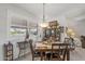 Well-lit dining room features a pendant light fixture, and a large window offering plenty of natural light at 10801 W Mountain View Rd, Sun City, AZ 85351