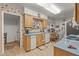 Charming kitchen with light wood cabinets, blue countertops, and a view of the breakfast nook at 10801 W Mountain View Rd, Sun City, AZ 85351