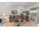 Relaxing living room featuring comfortable seating, patterned accents, and a seamless flow to outdoor spaces at 10801 W Mountain View Rd, Sun City, AZ 85351