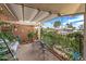Inviting outdoor patio featuring a charming swing, lush greenery, and decorative touches, creating a cozy retreat at 10801 W Mountain View Rd, Sun City, AZ 85351