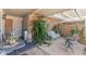 Relaxing outdoor patio with a comfortable swing and quaint decorations, perfect for enjoying the fresh air and serene views at 10801 W Mountain View Rd, Sun City, AZ 85351