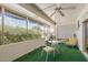 Bright sun room with white brick walls, and plenty of windows offering serene views of the neighborhood landscaping at 10801 W Mountain View Rd, Sun City, AZ 85351