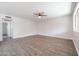 Bright, spacious bedroom with hard surface flooring, a ceiling fan, and a large window at 1085 N 84Th Pl, Scottsdale, AZ 85257