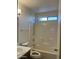 Bright bathroom featuring a tiled shower-over-tub, with neutral paint tones and natural lighting at 11207 N 59Th Dr, Glendale, AZ 85304