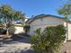 Lovely home features a well-maintained yard and convenient driveway leading to the garage at 11207 N 59Th Dr, Glendale, AZ 85304