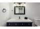 Bathroom featuring navy blue vanity with a white countertop and contemporary lighting fixtures at 12235 N 36Th Dr, Phoenix, AZ 85029