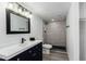 Updated bathroom features modern vanity, new fixtures, and a beautifully tiled shower at 12235 N 36Th Dr, Phoenix, AZ 85029
