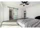 Bright bedroom featuring light-colored flooring and a sliding barn door to the bathroom at 12235 N 36Th Dr, Phoenix, AZ 85029