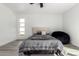 Comfortable bedroom features light-colored flooring, neutral walls, and a window with natural light at 12235 N 36Th Dr, Phoenix, AZ 85029