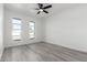 Bedroom with wood-look gray floors and two windows providing natural light at 12235 N 36Th Dr, Phoenix, AZ 85029