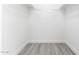 Walk-in closet with two shelves and modern gray floors at 12235 N 36Th Dr, Phoenix, AZ 85029