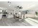 Spacious open-concept area with modern dining set, laminate flooring, kitchen access, and inviting ambiance at 12235 N 36Th Dr, Phoenix, AZ 85029