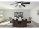 Dining area with a modern table setting and contemporary chairs, complemented by laminate floors and sliding glass doors at 12235 N 36Th Dr, Phoenix, AZ 85029