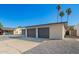 Attached two-car garage offering ample parking space and convenient access, complemented by clean landscaping at 12235 N 36Th Dr, Phoenix, AZ 85029