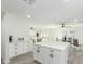Bright kitchen and dining area featuring white cabinets, kitchen island, and stainless steel appliances at 12235 N 36Th Dr, Phoenix, AZ 85029