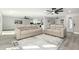 Open-concept living space featuring laminate flooring, neutral furniture, and seamless flow to the dining area at 12235 N 36Th Dr, Phoenix, AZ 85029