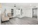 Bright living room with light-colored wood flooring, neutral walls, and comfortable seating at 12235 N 36Th Dr, Phoenix, AZ 85029