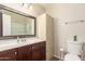 Well-lit bathroom boasts vanity storage, a single sink, and a functional shower/tub combination at 1575 W Hazelwood St, Phoenix, AZ 85015