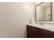 A cozy powder room has a single sink and a decorative mirror at 1575 W Hazelwood St, Phoenix, AZ 85015
