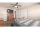 This bedroom showcases a dresser, mounted TV, and a comfortable upholstered bench at 1575 W Hazelwood St, Phoenix, AZ 85015