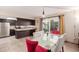 Dining area featuring updated light fixture and access to a sliding glass door to the outside at 1575 W Hazelwood St, Phoenix, AZ 85015