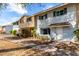 Attractive townhome with a mix of brick and siding, complemented by greenery and a paved path at 1575 W Hazelwood St, Phoenix, AZ 85015
