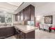 Bright kitchen features tiled countertops and backsplash that transitions to an open dining area at 1575 W Hazelwood St, Phoenix, AZ 85015