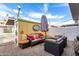 Cozy outdoor patio setting with comfortable seating, umbrella, and charming decor at 1575 W Hazelwood St, Phoenix, AZ 85015