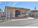 Charming home exterior featuring a covered porch and beautifully designed stained concrete driveway at 17200 W Bell Rd # 1119, Surprise, AZ 85374