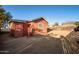 Backyard showing home's exterior, gas meter and door to outdoor storage at 1919 E Libby St, Phoenix, AZ 85022