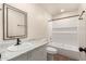 Bathroom featuring a marble vanity, framed mirror, and bathtub with shower and tile surround at 1919 E Libby St, Phoenix, AZ 85022