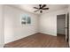 Bedroom features hardwood floors, a ceiling fan, and a window bringing in natural light at 1919 E Libby St, Phoenix, AZ 85022