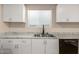 Close-up showcasing kitchen sink, cabinetry, and a dishwasher at 1919 E Libby St, Phoenix, AZ 85022