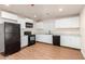 Well-lit kitchen area features white cabinetry and black appliances at 1919 E Libby St, Phoenix, AZ 85022