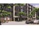 Contemporary apartment building with a neutral color palette and lush green trees on a sunny day at 19355 N 73Rd Way # 4016, Scottsdale, AZ 85255