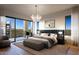 Bright main bedroom featuring modern decor, balcony access, and hardwood floors at 19355 N 73Rd Way # 4016, Scottsdale, AZ 85255