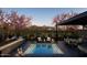 Backyard pool area featuring a fire pit, covered dining, lounge chairs and mountain views at 19355 N 73Rd Way # 4016, Scottsdale, AZ 85255