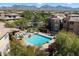 Aerial view of the community pool and lush landscaping, set against a mountain backdrop at 19777 N 76Th St # 1272, Scottsdale, AZ 85255