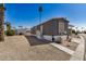 Charming gray home with desert landscaping and a tall palm tree at 201 S Greenfield Rd # 254, Mesa, AZ 85206