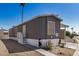 Charming gray home featuring a cozy porch and desert landscaping at 201 S Greenfield Rd # 254, Mesa, AZ 85206