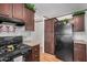 Modern kitchen featuring dark wood cabinets and black appliances at 201 S Greenfield Rd # 254, Mesa, AZ 85206