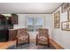 Bright living room featuring wood floors and classic armchairs at 201 S Greenfield Rd # 254, Mesa, AZ 85206