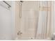 A shower stall with white tile, a handheld shower head and a shower curtain at 201 S Greenfield Rd # 254, Mesa, AZ 85206