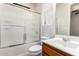 Bright bathroom featuring a shower over the bath, a toilet, and a sink with dark wood cabinets at 2090 S Dorsey Ln # 1020, Tempe, AZ 85282