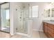 Bathroom featuring a glass shower, wood cabinets, and a sliding-glass door with access to a balcony at 2090 S Dorsey Ln # 1020, Tempe, AZ 85282