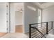 Upstairs hallway with open doorways to bedrooms and a modern railing at 2090 S Dorsey Ln # 1020, Tempe, AZ 85282