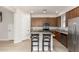 Modern kitchen features stainless steel appliances, a center island, and wooden cabinetry at 2090 S Dorsey Ln # 1020, Tempe, AZ 85282