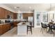 Modern kitchen with granite countertops, stainless steel appliances, island with seating, and a dining table at 2090 S Dorsey Ln # 1020, Tempe, AZ 85282