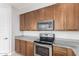 Bright kitchen showcasing stainless steel appliances, granite countertops and natural wood cabinets at 2090 S Dorsey Ln # 1020, Tempe, AZ 85282