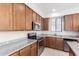 Bright kitchen showcasing stainless steel appliances, granite countertops and natural wood cabinets at 2090 S Dorsey Ln # 1020, Tempe, AZ 85282